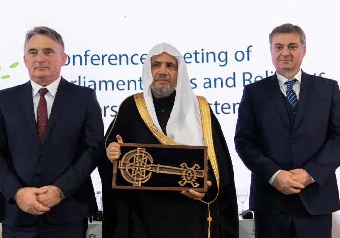 ‏عمدة سراييفو، السيدة بنيامينا كاريتش، تُسَلِّمُ معالي الأمين العام، الشيخ د.⁧‫محمد العيسى‬⁩ "مفتاحَ مدينة سراييفو"
